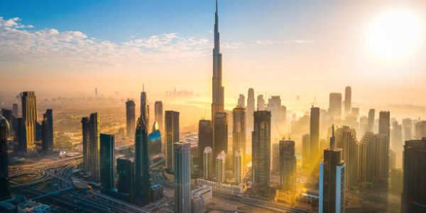 Aerial skyline of downtown Dubai filled with modern skyscrapers in the United Arab Emirates rising above the main city highway aerial view at sunrise